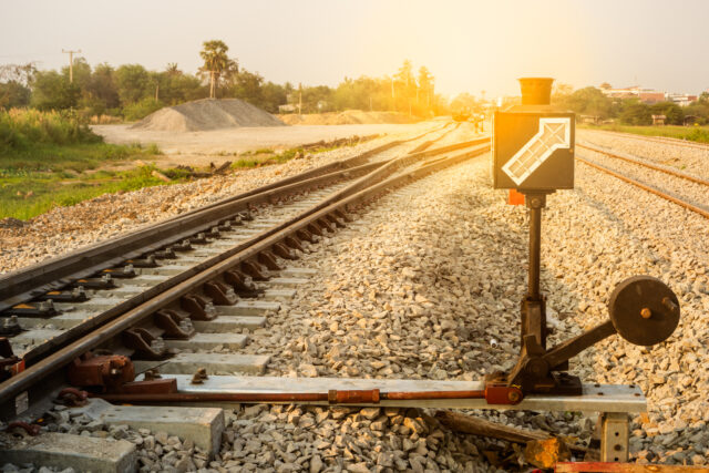 Hand-operated railroad switch with lever and signal.