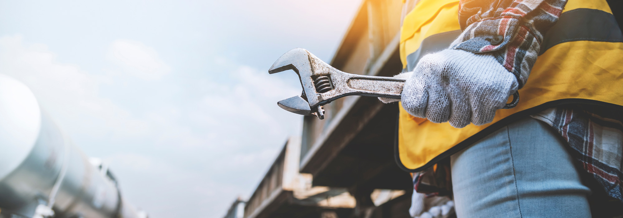 hands of engineer woman holding wrench for repair working on train