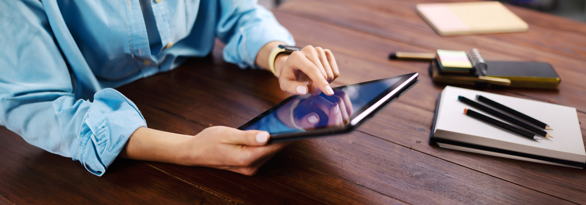 woman pointing on digital tablet screen